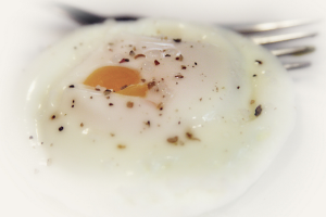 How long to poach an egg in the microwave? A single, runny poached egg from a microwave.