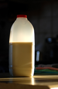 How Much Protein In Milk, a half filled bottle of milk.