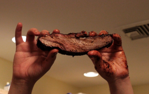 How To Cook Brisket In A Slow Cooker, holding up some slow oven cooked brisket.